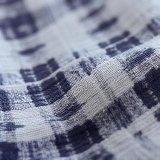 Close-up view of printed textile showing subtle color bleeding at the edges of a pattern